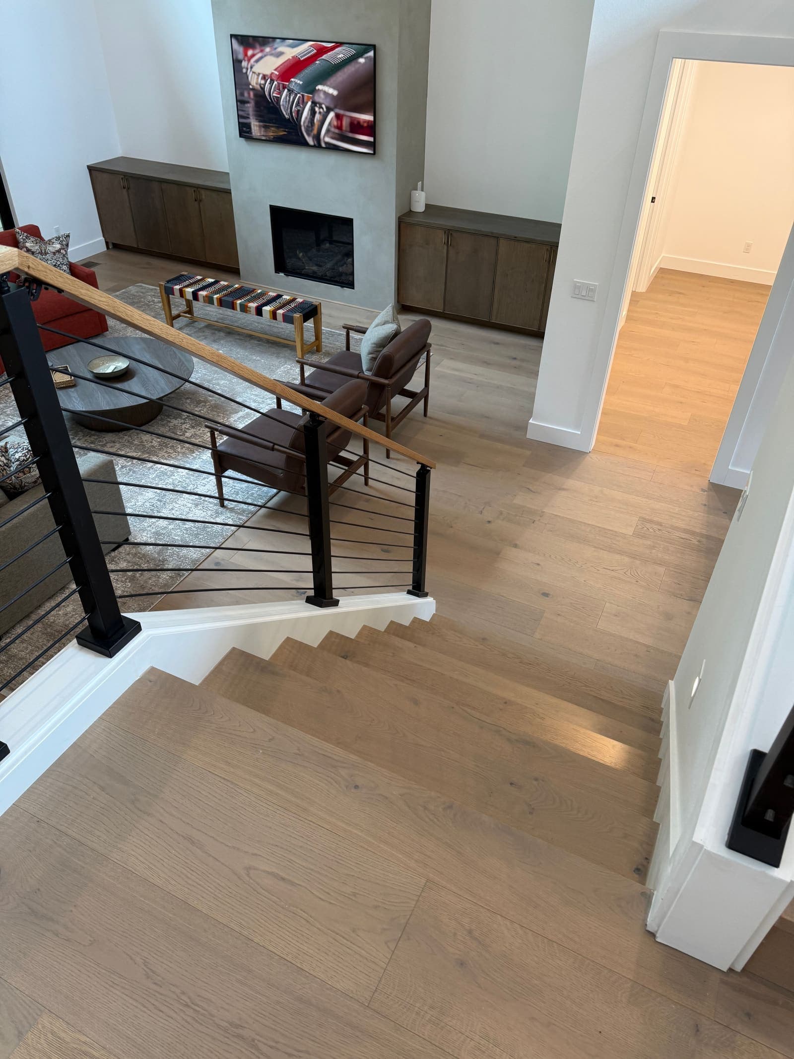 Wide-plank engineered hardwood flooring on stairs and living room — Skyview Flooring project in Forest Heights, Portland, OR