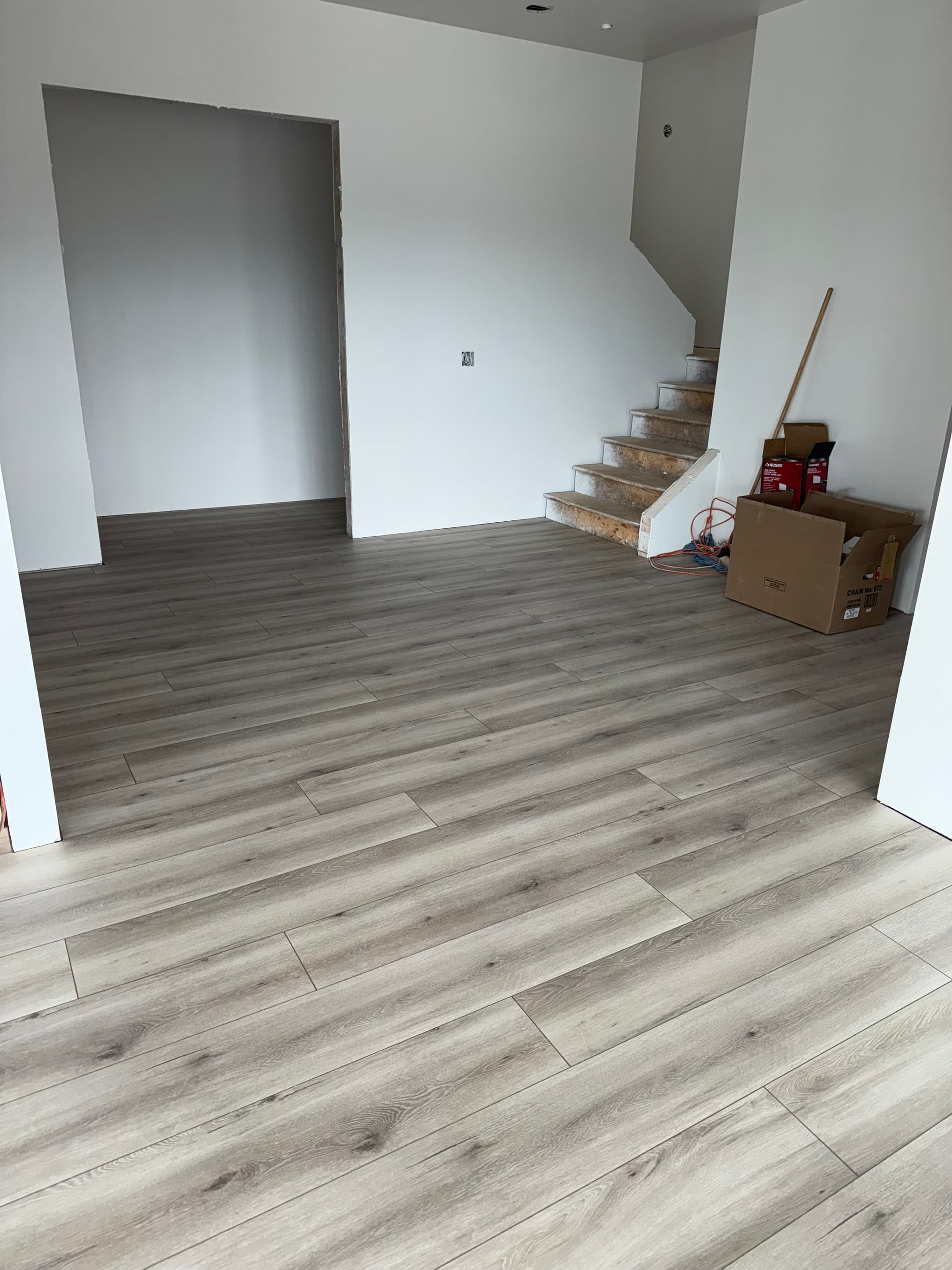 Living room laminate flooring with staircase — Camas, WA