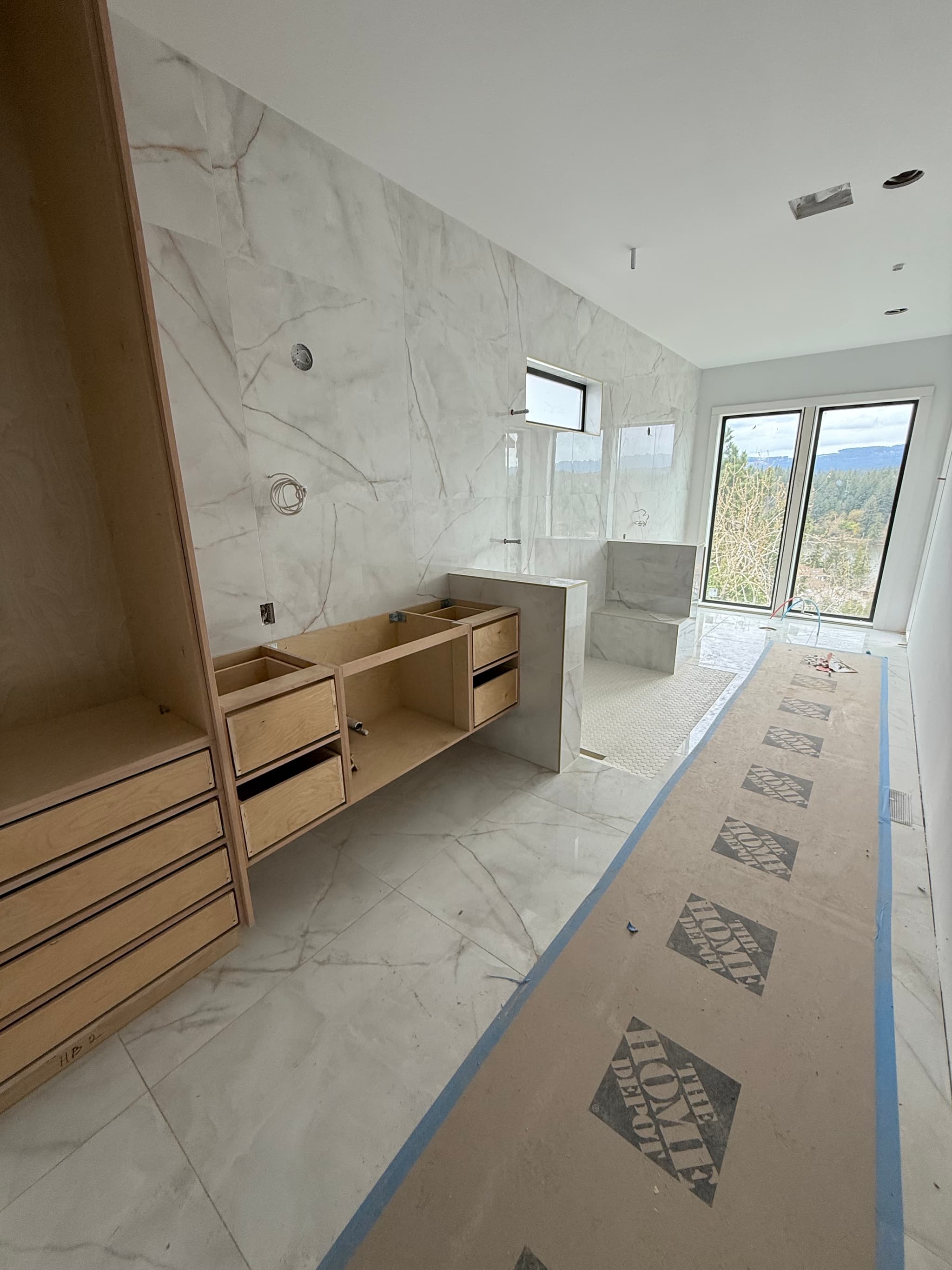 Wide view of porcelain tile shower with penny tile floor — Camas, WA